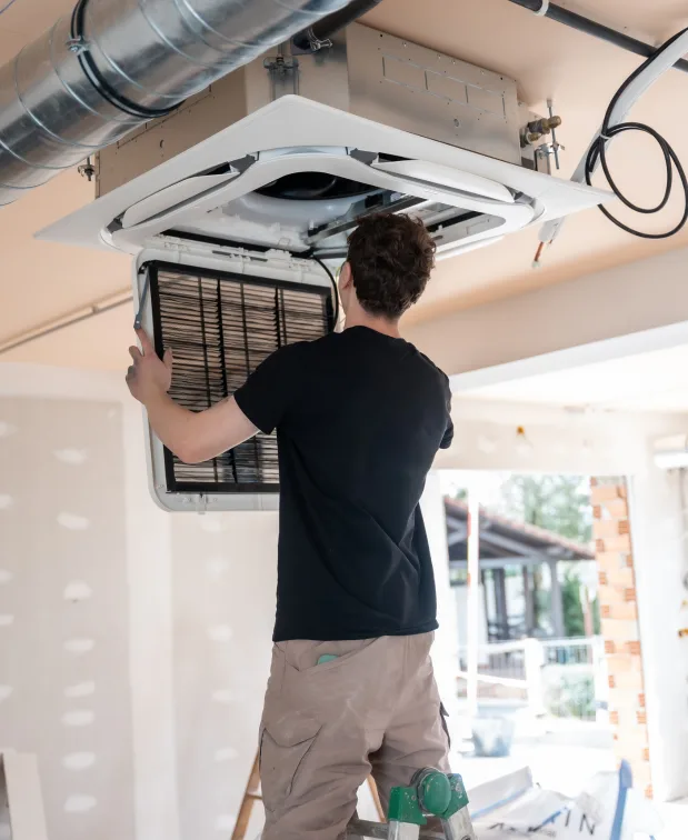 Hot and Cool HVAC technician completing an air conditioning service call