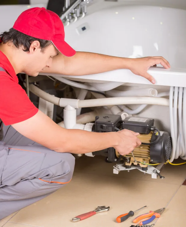 Plumber working on residential pipes and plumbing fixtures